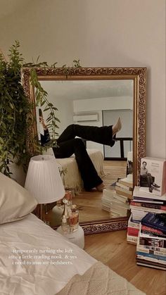 a person laying on a bed in front of a mirror