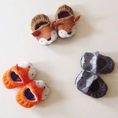 three pairs of baby shoes with animals on them