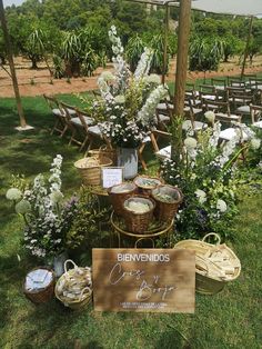 an outdoor ceremony setup with flowers and baskets