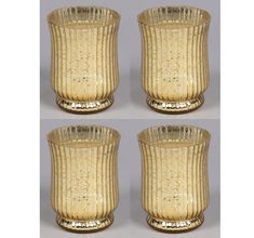 four gold colored glass candlesticks on a white background