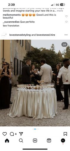 people standing around a table with food on it