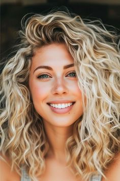 Mid-Length Curls with Deep Side Part Hairstyle on smiling young woman with blonde hair. Shoulder Length Curly Haircuts Natural Curls, Shoulder Length Curly Haircuts, Curly Hair Side Part, Moisturizing Hair Oil, Medium Length Curls, Shoulder Length Curls, Deep Side Part, Curly Lob, Shoulder Length Curly Hair