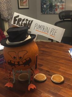 a pumpkin sitting on top of a wooden table