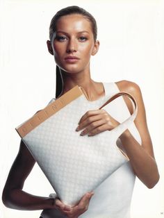 a woman holding a large white bag in her hands