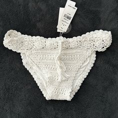 White Crochet Bikini Bottoms With Tie In Front. Small Tear In Crochet As Pictured Beachy White Bottoms For Festival, Stretch Swimwear With Crochet Trim For Summer, White String Bottoms For Pool, Summer Swimwear With Crochet Trim And Stretch Fit, Fitted Beach Bottoms With Crochet Trim, White Crochet Trim Bottoms For Beach Season, White Crochet Trim Vacation Bottoms, White Bottoms With Crochet Trim For Beach Season, Summer Lace Swimwear With Stretch