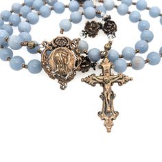 rosary with blue angel stone beads and a bronze crucifix and a bronze center showing a profile of our lady.  Also shown are bronze rose our father beads. Rosary Making, Pray The Rosary, Ribbon Style, Blue Angel, Blue Angels, Enamel Earrings, Lost Wax, Artisan Craft, Our Lady