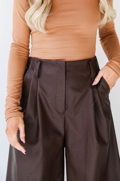 No matter the celebration, the Exceptional Vision Brown Leather Culotte Pants will enhance your beautiful glow! Crafted with meticulous attention to detail, these culottes redefine contemporary fashion with a touch of timeless elegance. The rich brown leather exudes a warm and luxurious feel, creating a versatile piece that effortlessly transitions from day to night. The culotte silhouette adds a modern twist to the classic leather pants, offering a relaxed yet tailored fit. The wide-leg design Chic High Waist Formal Shorts, High Waist Shorts For Fall Date Night, Short Length Bottoms For Date Night In Fall, Short-length Bottoms For Date Night And Fall, Elegant Shorts For Night Out In Fall, Chic Wide Leg Fall Shorts, Chic Bottoms With Built-in Shorts For Fall, Elegant High-waisted Shorts For Party, Elegant Party Bottoms With Built-in Shorts