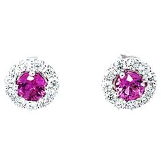 These gorgeous pink sapphire earrings feature a beautifully matched pair of vibrant pink sapphires framed by a sparkling halo of brilliant white diamonds! Set in 18k white gold, these stud earrings are the perfect complement for any outfit, day or night. A matched pair of pink sapphires with such saturated, bright color is rare - these earrings will be appreciated and treasured by anyone who knows and loves fine jewelry and remarkable gemstones! Pink sapphires, 4.92mm, 1.18 carats total 22 round brilliant-cut diamonds, .77 carats total Pink Sapphire Earrings, Halo Stud Earrings, Halo Earrings Studs, Sapphire Earrings, Diamond Halo, Sapphire Diamond, White Diamonds, Round Brilliant Cut Diamond, Round Brilliant Cut