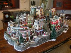 a christmas village is displayed on a table