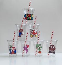 the cups have different designs on them and are lined up with straws to match