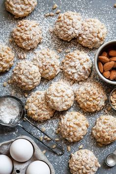 almond cookies with powdered sugar and spoons next to them