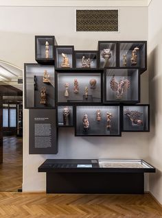 a display case filled with lots of different types of figurines on black shelves