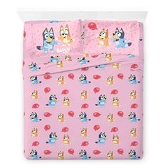 a pink bed set with cartoon characters and mushrooms on the sheets, in front of a white background