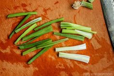 green onions are cut up on a cutting board