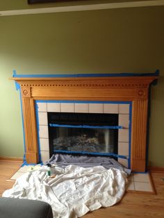 a living room with a fireplace being painted