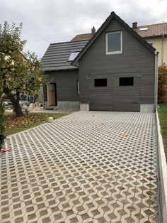 a house with a large driveway in front of it