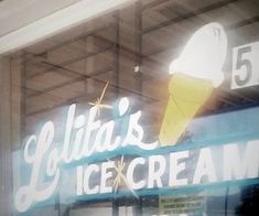 an ice cream shop sign in the window