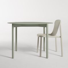 the table and chair are all in different colors, but there is no one sitting at it