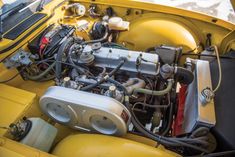 the engine compartment of an old yellow truck