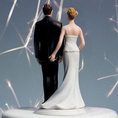 a bride and groom are looking at the sky with fireworks in the air behind them