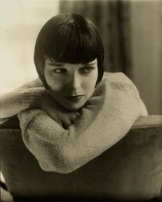 a black and white photo of a woman with short hair