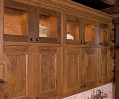 the cabinets in this kitchen are made of wood and have glass inserts on them