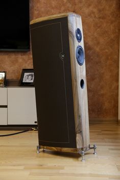 a large wooden speaker sitting on top of a hard wood floor