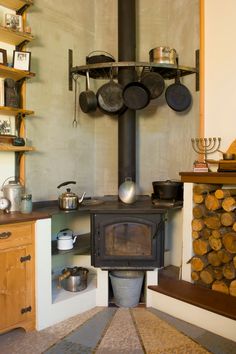 an old fashioned stove with pots and pans on it's burners in a kitchen