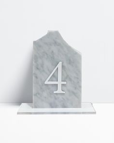 the number four is on top of a marble block