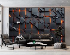 a living room filled with furniture and a wall covered in black tiles on the side