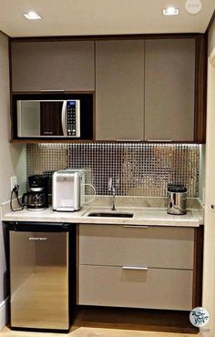 a small kitchen with stainless steel appliances and cabinets