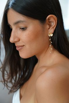 a close up of a person wearing some kind of earring with flowers on it