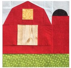 a red barn quilted on top of a green and white tablecloth with a black cat sitting in the window