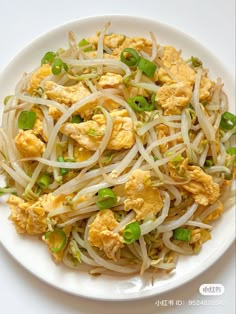 a white plate topped with noodles and vegetables