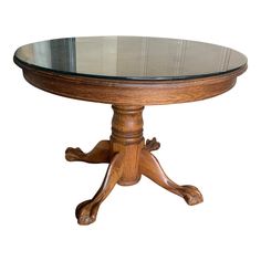 a round wooden table with glass top