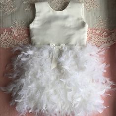 Hand made dress for girl. Your child will be like a princess in this dress. Can be as gift for girl or dress for birthday party. Color can be changed for your wish. If you need headband or jacket that matches this dress, I will make it in order. Size in centimeters 12-18 months: waist - 48-50 chest - 51-53 skirt length 21 12-24 months: waist - 49-51 chest - 52-54 skirt length 23 2 years: waist - 50-52 chest - 53-55 skirt length 25 3 years: waist - 51-53 chest - 54-56 skirt length - 27 4 years: w Elegant Feather Trim Dress For Pageant, White Sleeveless Dresses With Feathers, Sleeveless White Dress With Feathers, White Sleeveless Dress With Feathers, Elegant Feather Trim Dresses For Dress-up, Elegant Dress With Feather Trim For Dress-up, Princess Dresses With Feather Trim For Dress-up, Princess Style Dresses With Feather Trim For Dress-up, Feather Trim Tulle Dresses For Pageants