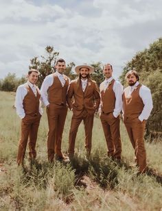 a group of men standing next to each other in a field