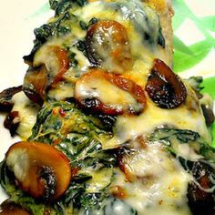 an image of a plate of food with mushrooms and spinach on it's side