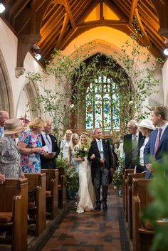 the bride and groom are walking down the aisle