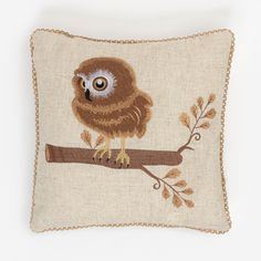 an owl is sitting on a branch embroidered pillow