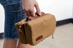 a person holding a brown bag in their left hand and the other hand is pulling it out