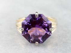 Outstanding! This solitaire cocktail ring is all about the gemstone. One, simple, solitary gem, set up in the modernist style. The clean geometric lines of this fancy cut allow this wonderful amethyst to sparkle with undertones of regal purple and raspberry, we've set this stone into a simple two-tone gold mounting creating a sophisticated statement piece! Metal: 14K Yellow and White Gold  Gem: Amethyst 4.20 Carats  Gem Measurements: 13.0 mm, Octagon Ring Size: 6.50 Marks: "IJS14K" Stamped on the inside band Octagon Ring, Amethyst Cocktail Ring, Gold Amethyst Ring, Bypass Ring, Purple Band, Birthstone Gifts, Geometric Lines, February Birth Stone, Metal Pendant