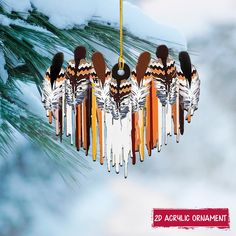 an ornament hanging from a pine tree with skis and snow on it