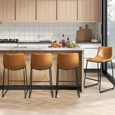 a kitchen with wooden cabinets and stools next to an island in the middle of it