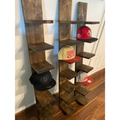 three wooden shelves with hats on them in a room next to a wall and hardwood flooring