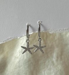 Gorgeous Boho Costal Grandma style sparkly starfish earrings beautiful for any occasion. Made to be worn alone all also to stacked.  This stunning earrings are hypoallergenic (lead and nickel free).  Perfect for everyday wear as they are Tarnish resist and waterproof,  Hoop diameter : 10mm Earrings are sold individually or as a pair  Made with 925 Sterling silver.  They are light weight. Easy to wear. Tarnish resist and sweat/waterproof, perfect for everyday wear.  All jewellery is beautifully p Handmade Silver Starfish Earrings, Nickel Free Silver Starfish Earrings, Nickel-free Silver Starfish Earrings, Nickel-free Star-shaped Huggie Earrings, Sterling Silver Starfish Earrings In Silver, Summer Earrings With Starfish Charm, Silver Sterling Silver Starfish Earrings, Trendy Star Charm Jewelry For Summer, Trendy Summer Jewelry With Star Charm