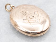 Elegant and timeless, this yellow gold Masonic locket is the perfect accessory for any member of the fraternal organization. The delicate "AD" engraving adds a touch of personalization. Made with expert craftsmanship, this locket is a symbol of pride and tradition. This pendant does not come with the chain shown. Don't hesitate to get in touch with us, we will help you find the perfect chain for your style and budget! Metal: 10K Yellow Gold Monogram: "AD" in French Script Measurements: 21 x 32 mm, with bail SKU #: A42931 Each piece has been identified and graded by a Graduate Gemologist who has been certified by the Gemological Institute of America (GIA). We have six brick-and-mortar storefronts in Maine, Massachusetts, and New Hampshire and have been in business for over 25 years! Please Traditional Formal Jewelry With Engraving Option, Traditional Jewelry With Engraving Option For Formal Occasions, Engraved Yellow Gold Jewelry For Ceremonial Occasions, Timeless Hallmarked Jewelry For Ceremonial Occasions, Ceremonial Yellow Gold Jewelry With Engraving Option, Traditional Gold Jewelry With Engraving Option, Commemorative Yellow Gold Locket Jewelry, Victorian Jewelry With Engraving Option For Ceremonial Occasions, Ceremonial 14k Gold Stamped Medallion Jewelry