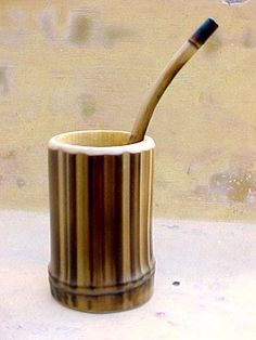 a wooden toothbrush holder sitting on top of a counter