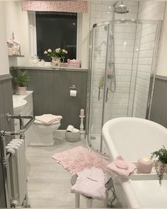 a bathroom with a bathtub, toilet and sink in it's center area