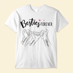 a white t - shirt with the words besties forever written on it and two hands holding